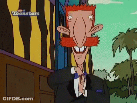 Red Mustache Tuxedo Character Standing In Front Of Toonsters Building GIF