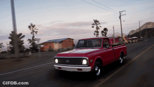 Red Pickup Truck Driving Down Road GIF