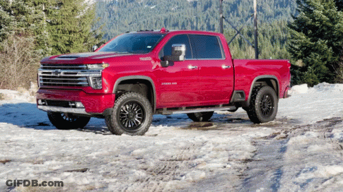 Red Pickup Truck Parked In Snow With Trees GIF