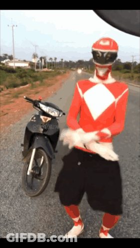 Red Power Ranger Standing Next To Motorcycle GIF