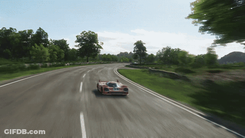 Red Race Car Driving On Road With Trees GIF