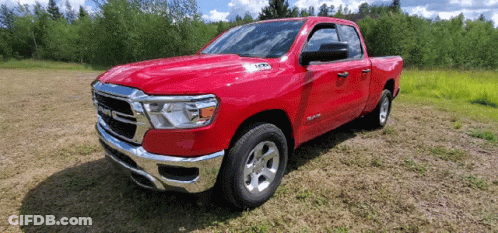 Red Ram Truck Parked On Grassy Field GIF