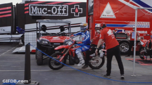Red Shirt Man By Motorcycle With Muc-Off Sign GIF