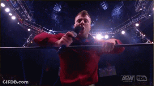 Red Shirt Man Holding Microphone AEW HDS Sign GIF