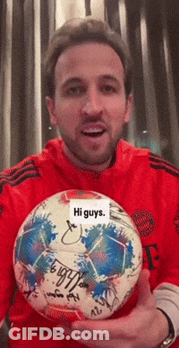 Red Shirt Man Holding Signed Soccer Ball Saying Hi Guys GIF