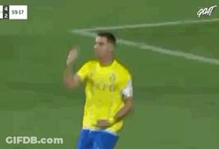 Red Shirt Referee Talking To Yellow Shirt Soccer Player GIF