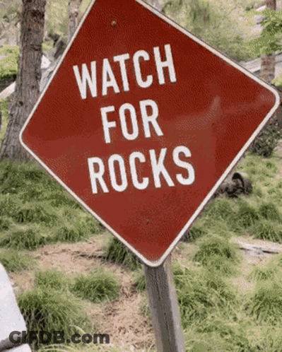 Red Sign Saying Watch For Rocks GIF