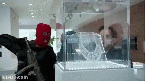 Red Ski Mask Man Looking At Necklace GIF
