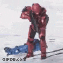 Red Soldier Standing By Laying Person With Gun GIF