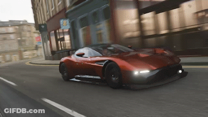 Red Sports Car Driving Down City Street GIF