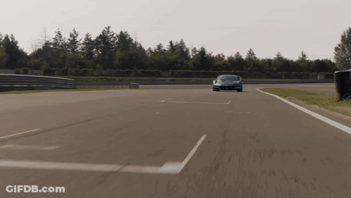 Red Sports Car Driving Down Road With White Line GIF