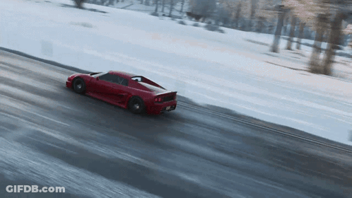 Red Sports Car Driving Down Snowy Road GIF