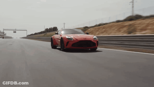 Red Sports Car Driving Past Sign Saying A GIF