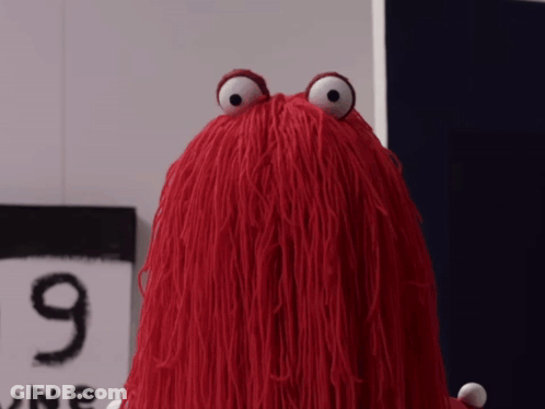 Red Stuffed Animal In Front Of 9 One Sign GIF