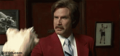 Red Suit Man Facing Shorts Man GIF