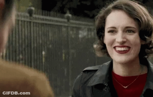 Red Sweater Black Coat Woman Smiling At Man GIF