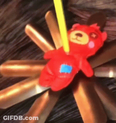 Red Teddy Bear Sitting On Pile Of Sticks GIF