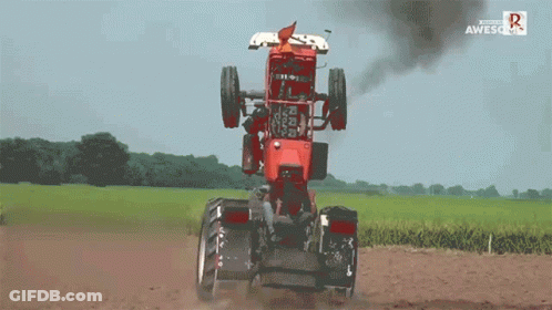 Red Tractor Driving Through Field Saying Awesome GIF
