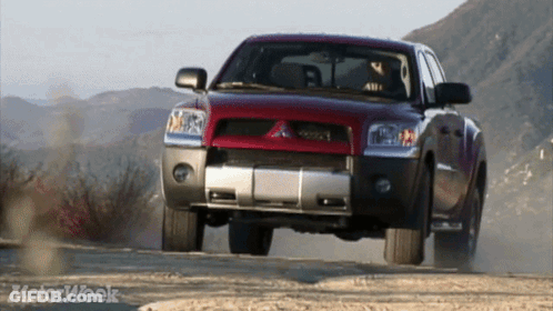 Red Truck Driving Down Dirt Road Motorweek GIF
