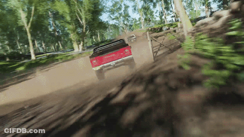 Red Truck Driving Down Dirt Road With Trees GIF