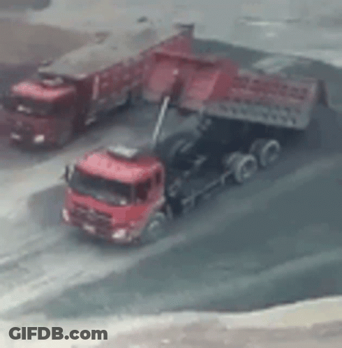 Red Trucks Parked On Dirt Road GIF