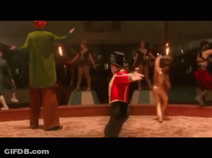 Red Uniform Man Dancing With Circus Clown Behind GIF