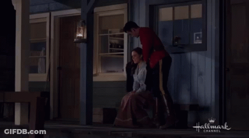 Red Uniform Man Sitting Beside Black Sweater Woman GIF