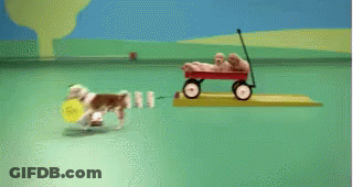 Red Wagon Filled With Puppies On Green Surface GIF
