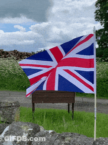 Red White And Blue British Flag Flying In Field GIF