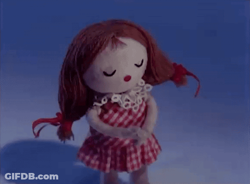 Redhead Doll In Checkered Dress Eyes Closed GIF