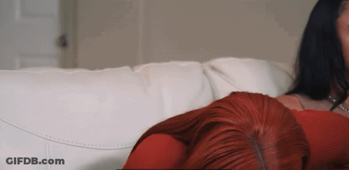 Redhead Laying On White Couch Next To Woman GIF