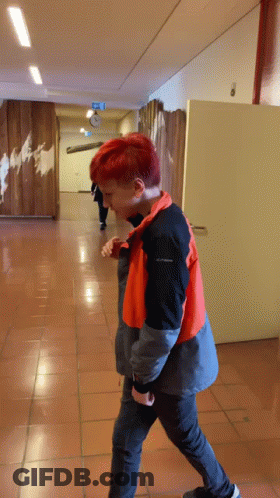 Redhead Walking Down Hallway In Columbia Jacket GIF