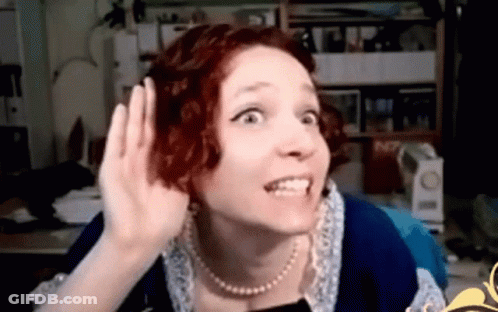 Redhead With Pearl Necklace Hand To Ear GIF