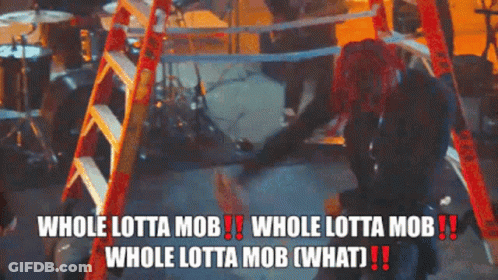 Redhead Woman Beside Ladder Says Whole Lotta Mob GIF