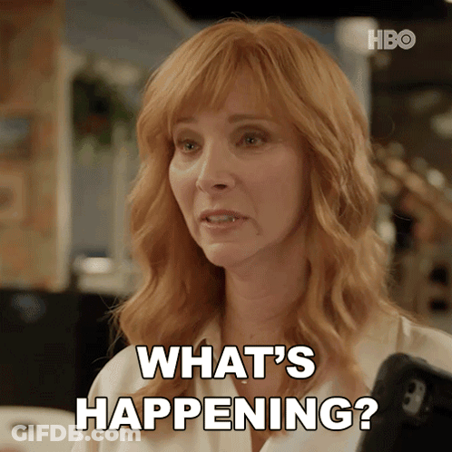 Redhead Woman Holding Cell Phone Saying What's Happening GIF