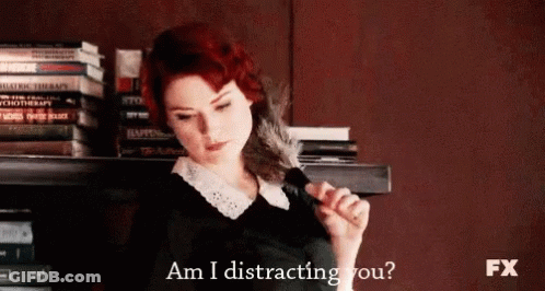 Redhead Woman Holding Feather Saying Am I Distracting You GIF