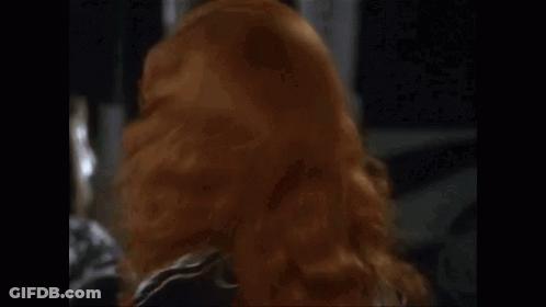 Redhead Woman In Black Dress Making Funny Face GIF
