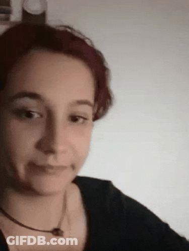 Redhead Woman In Black Shirt Making Funny Face GIF