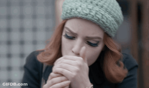 Redhead Woman In Green Knitted Hat Coughing GIF