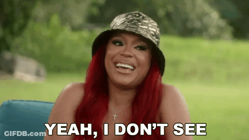 Redhead Woman In Hat Laughing On Couch GIF