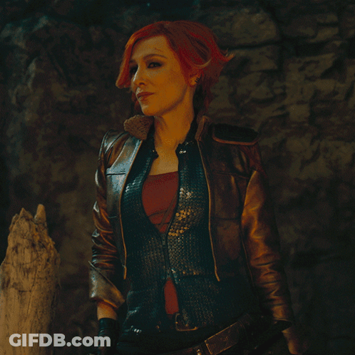 Redhead Woman In Leather Jacket And Vest GIF