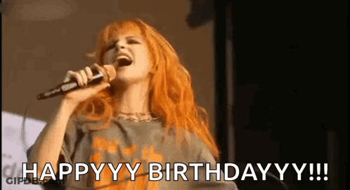 Redhead Woman Singing Happy Birthday Into Microphone GIF