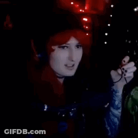 Redhead Woman Singing Into Microphone With Headphones GIF