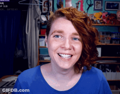 Redhead Woman Smiling At Gifted Sign GIF
