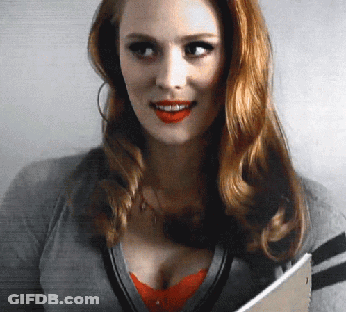 Redhead Woman Smiling Holding Book GIF