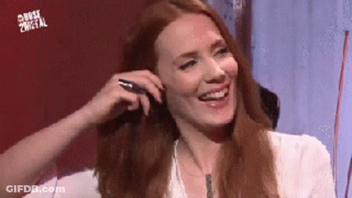 Redhead Woman Smiling Holding Pen GIF