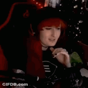 Redhead Woman Smoking In Chair By Christmas Tree GIF