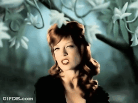 Redhead Woman Standing Under White Flower Tree GIF