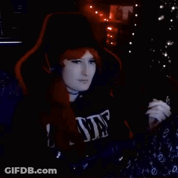 Redhead Woman Waving In Gaming Chair GIF