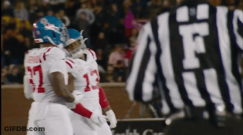 Referee Behind Football Player Number 13 GIF